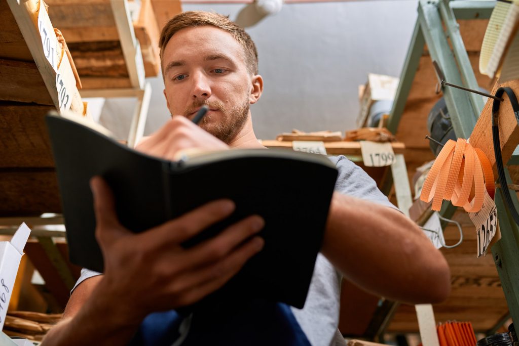 An employee checking stock inventory in a shop.